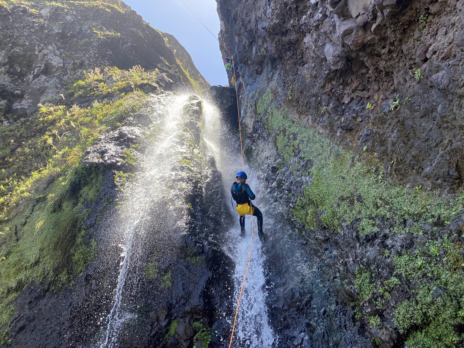 Canyoning Madeira — group rappelling down a waterfall on a private canyoning tour